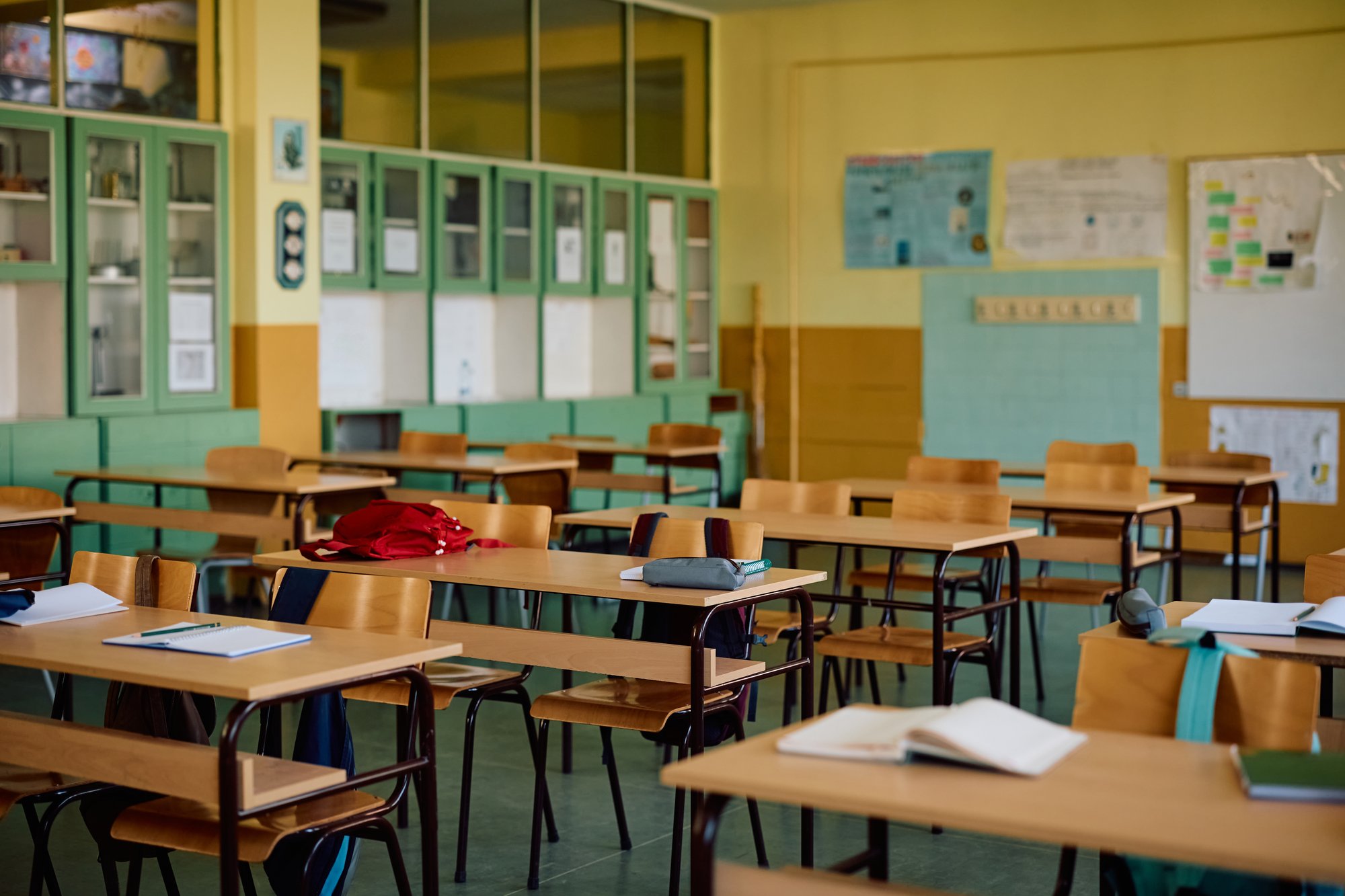 empty classroom with backpacks and books